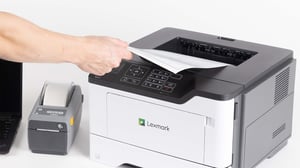 Person pulling paper from printer